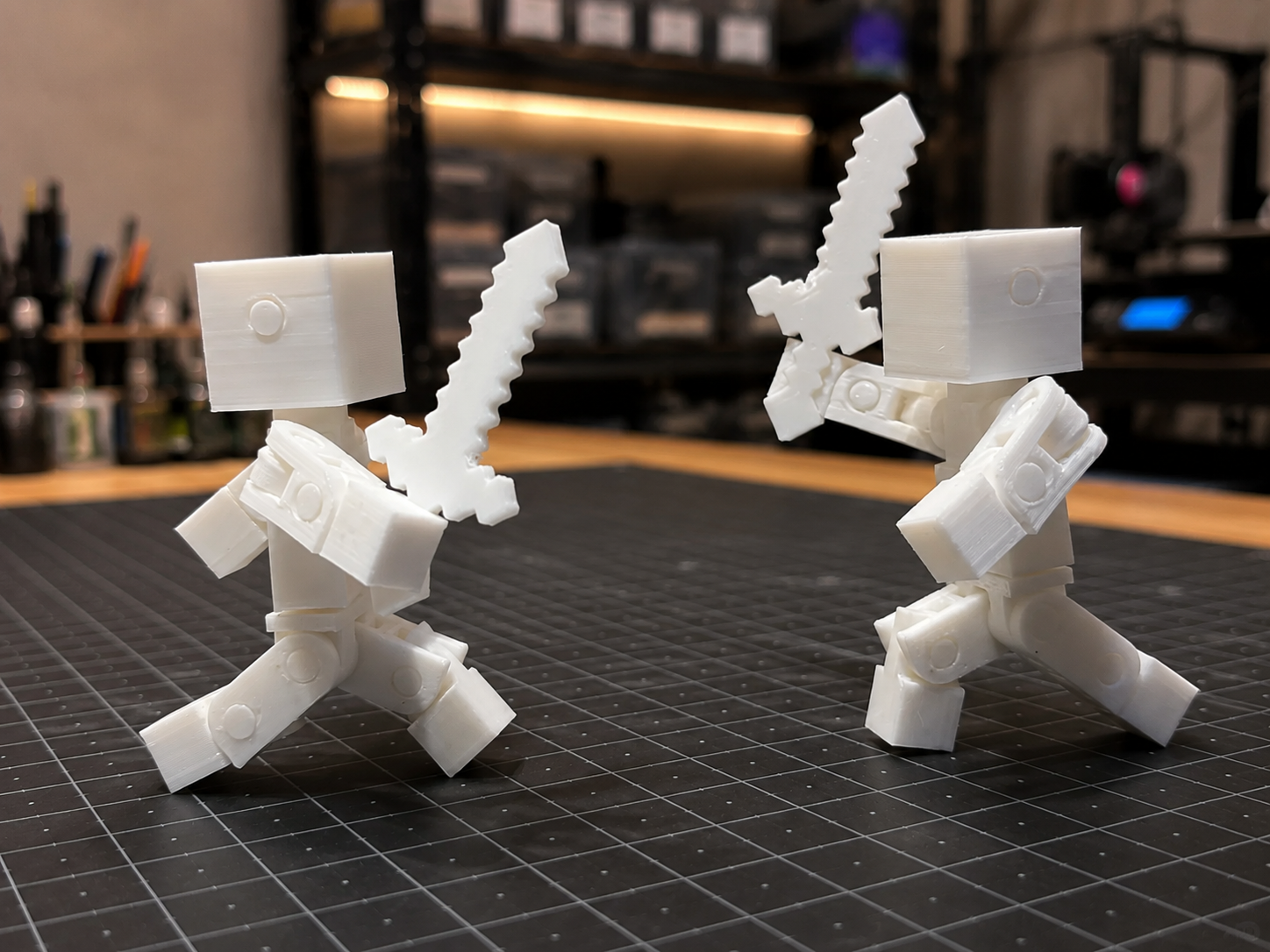Playful white 3D printed block characters with swords in the Figmo studio