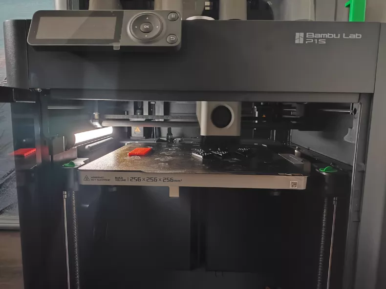 Bambu Lab 3D printer producing a custom Figmo part in the studio