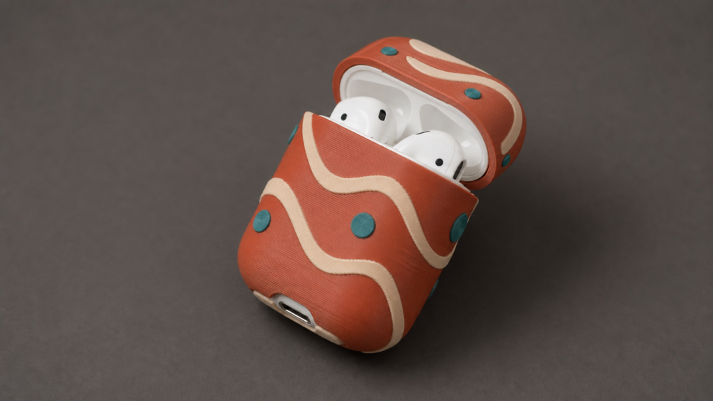 Open geometric 3D printed AirPods case cover showing lid clearance and charging-port access