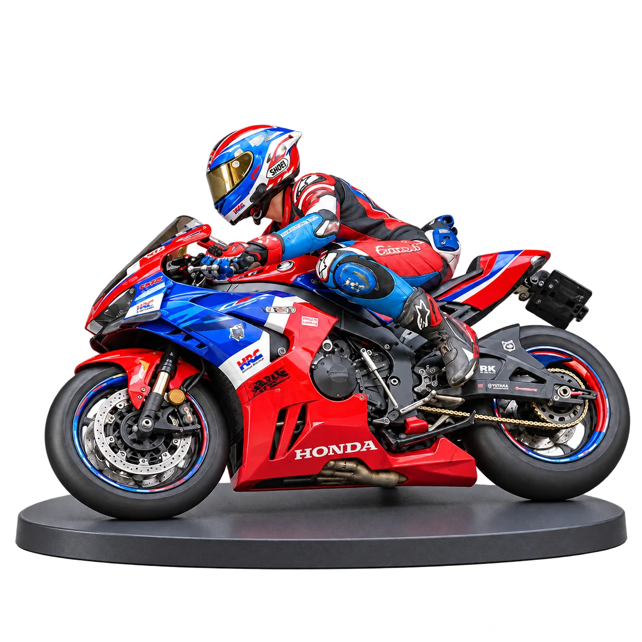 Red, white and blue sport motorcycle miniature with a rider in racing leathers on an oval base